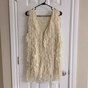 Cream colored sleeveless vest